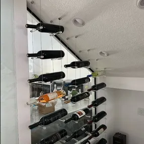 Cable and Acrylic wine racks in a modern wine cellar